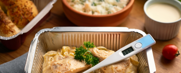 Food thermometer reading 165°F in a ready-to-heat meal